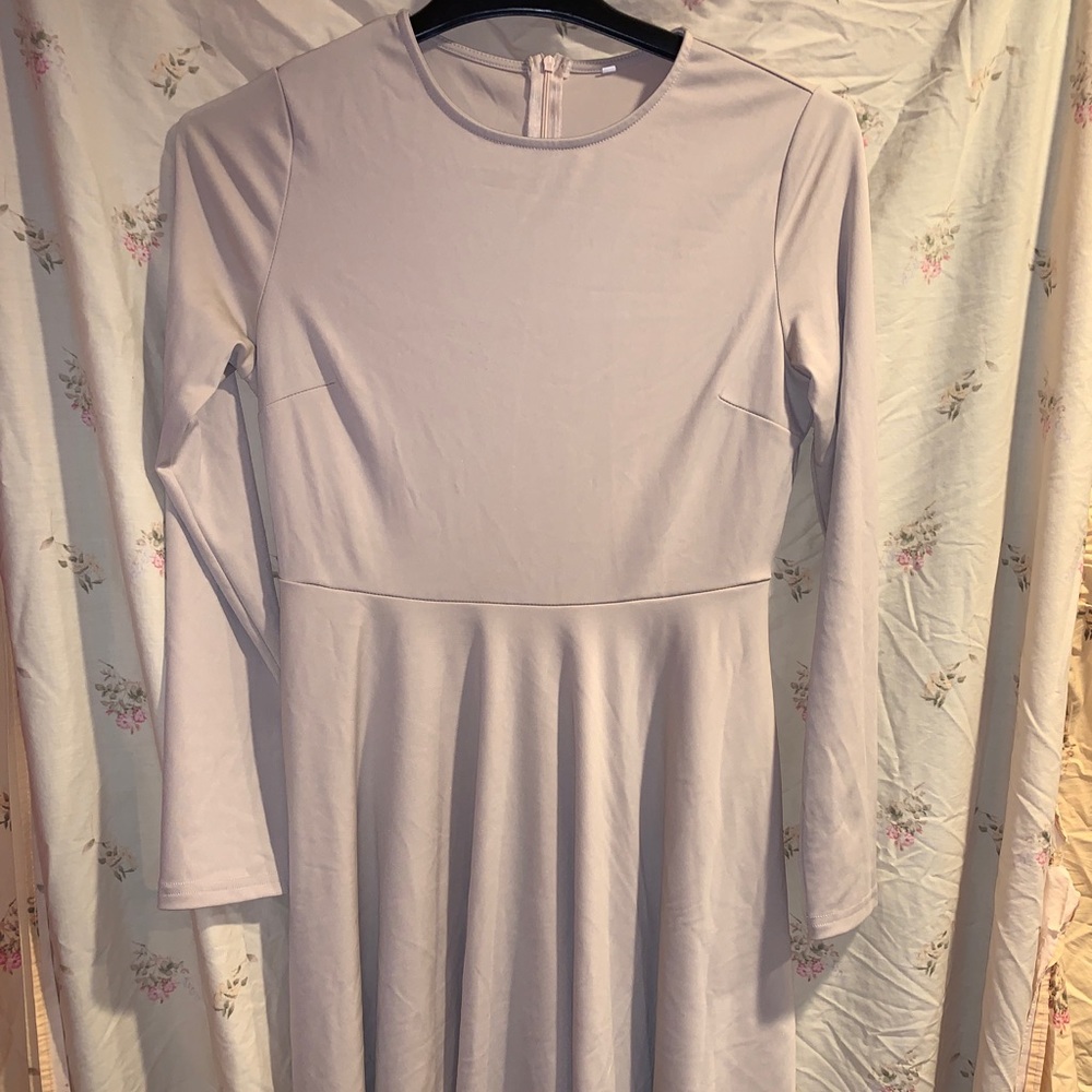 Knee length nude a-line dress.